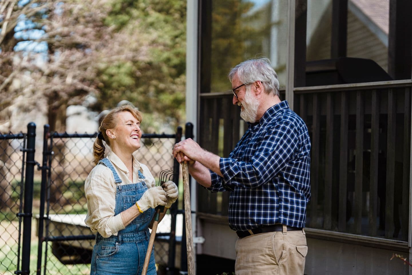 An older couple sharing a laugh while gardening together