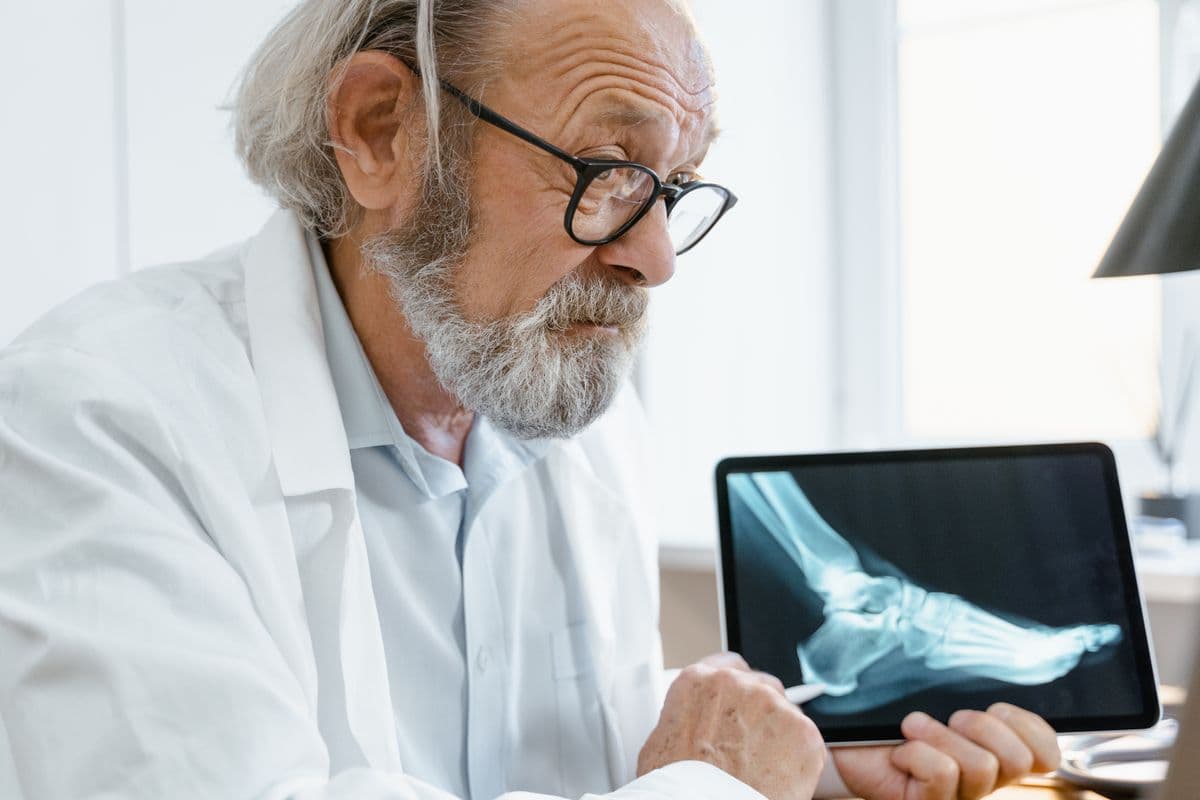 A doctor reviewing a medical image on a tablet